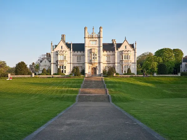 Tudor-gothic front of Ingress Abbey at the top of its long lawn in Greenhithe