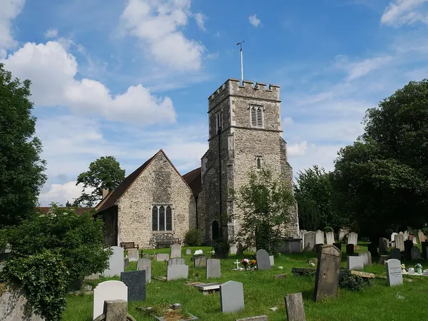 Flint and ragstone tower of St Paulinus Church above the churchyard on Church Hill, Crayford