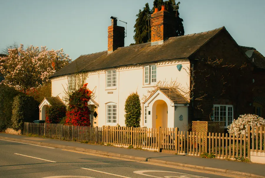 Brick and rendered cottage with chimneys and a tiled roof, the kind of local job worth asking a Dartford roofer for references on