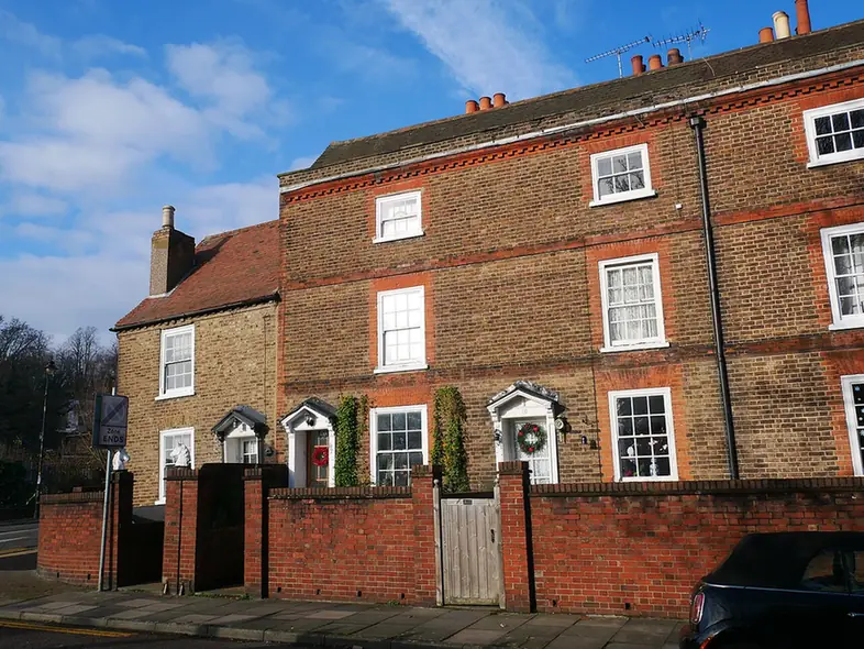 Listed Georgian brick terrace with tiled roof and chimneys at 56-64 Bexley Lane, Crayford
