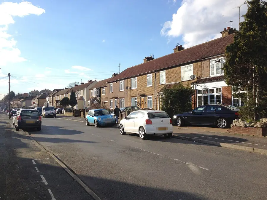 Brick terraced houses with pitched roofs along Green Walk, Crayford