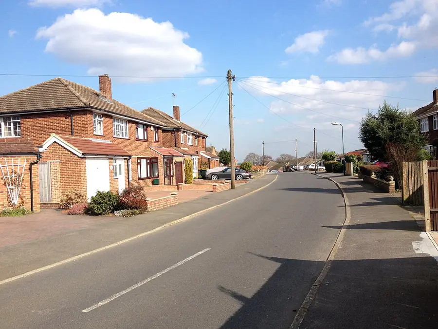 Brick houses with tiled roofs and garages on Squires Way, Joyden's Wood