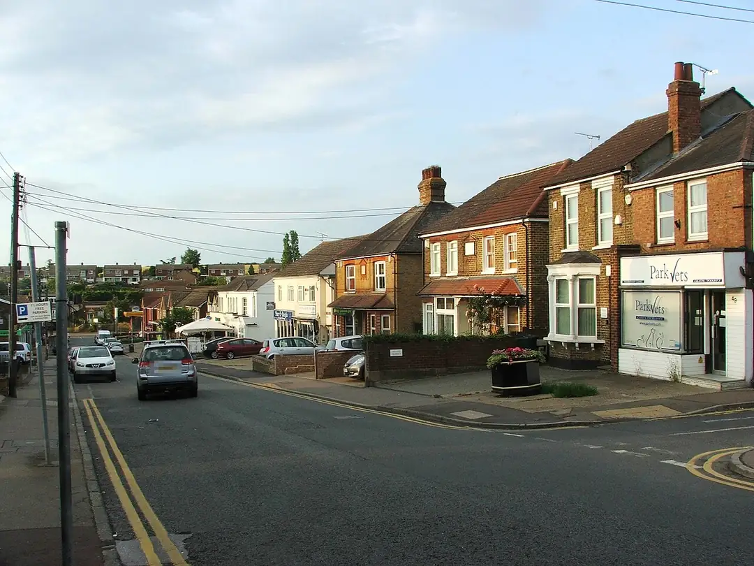 Edwardian brick houses with tiled roofs and chimneys on Station Road, Longfield